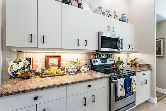 20 Long Pl, Palm Coast, FL 32137 - kitchen featuring appliances with stainless steel finishes, decorative backsplash, and white cabinetry
