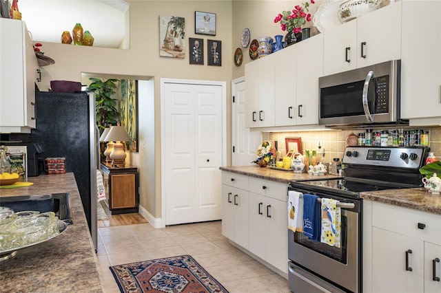 20 Long Pl, Palm Coast, FL 32137 - kitchen featuring appliances with stainless steel finishes, decorative backsplash, and white cabinets