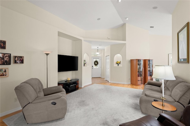 143 W Waterside Pkwy, Palm Coast, FL 32137 - living area featuring light wood finished floors, arched walkways, and high vaulted ceiling