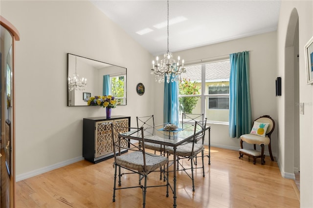 143 W Waterside Pkwy, Palm Coast, FL 32137 - dining area featuring a chandelier, plenty of natural light, light wood-style floors, and vaulted ceiling