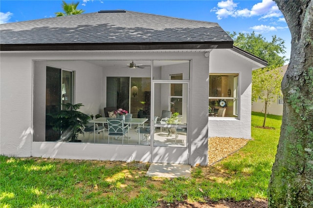 143 W Waterside Pkwy, Palm Coast, FL 32137 - back of house featuring roof with shingles, a ceiling fan, a lawn, and a sunroom