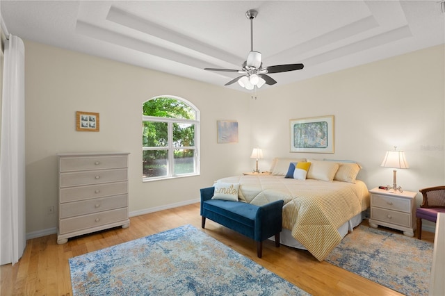 143 W Waterside Pkwy, Palm Coast, FL 32137 - bedroom featuring a raised ceiling, wood finished floors, and ceiling fan
