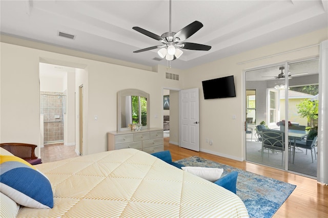 143 W Waterside Pkwy, Palm Coast, FL 32137 - bedroom featuring access to outside, a tray ceiling, and light wood finished floors