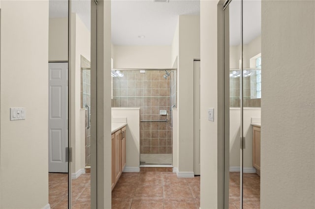 143 W Waterside Pkwy, Palm Coast, FL 32137 - bathroom with vanity, a tile shower, and tile patterned flooring
