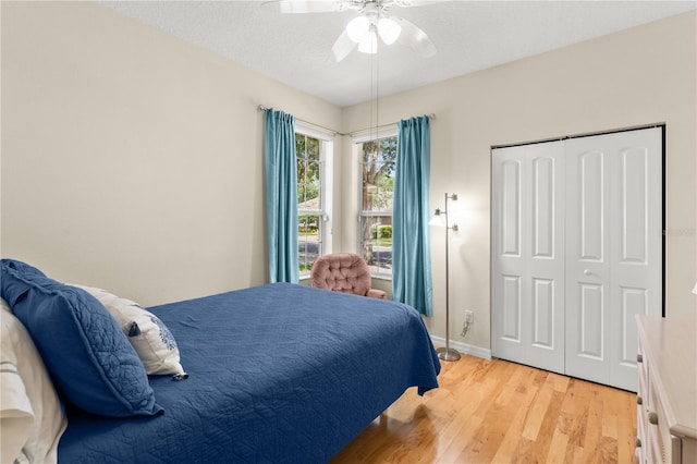 143 W Waterside Pkwy, Palm Coast, FL 32137 - bedroom with light wood-style floors, a closet, ceiling fan, and a textured ceiling