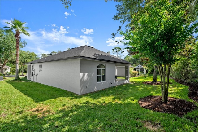 143 W Waterside Pkwy, Palm Coast, FL 32137 - view of home's exterior featuring a yard, stucco siding, and a shingled roof