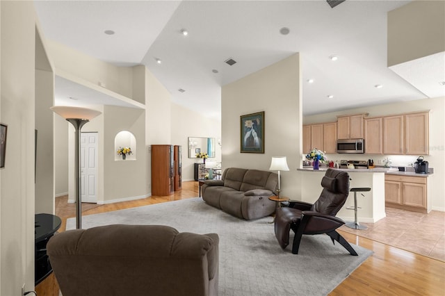 143 W Waterside Pkwy, Palm Coast, FL 32137 - living area featuring light wood-type flooring, high vaulted ceiling, and arched walkways