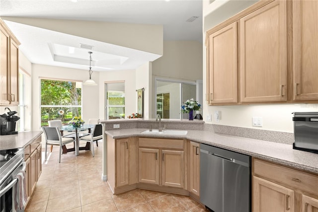143 W Waterside Pkwy, Palm Coast, FL 32137 - kitchen with appliances with stainless steel finishes, light brown cabinets, light tile patterned floors, and a peninsula