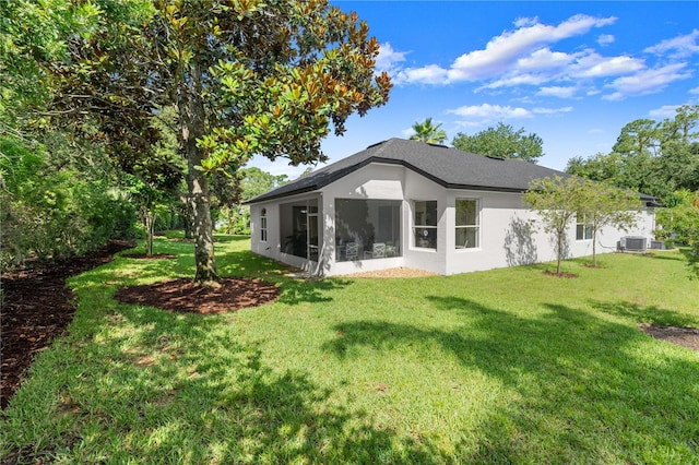 143 W Waterside Pkwy, Palm Coast, FL 32137 - back of house featuring a lawn, stucco siding, and a sunroom