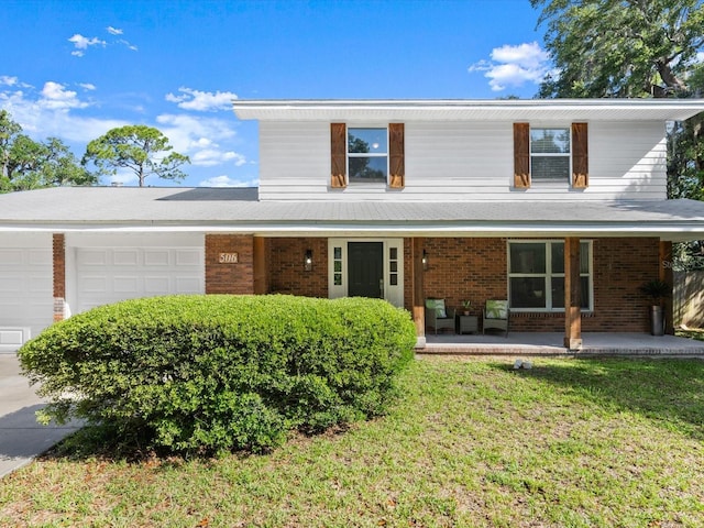 506 Dorset Cir S, Daytona, FL 32119 - view of front of house with a garage, brick siding, a porch, and a front lawn