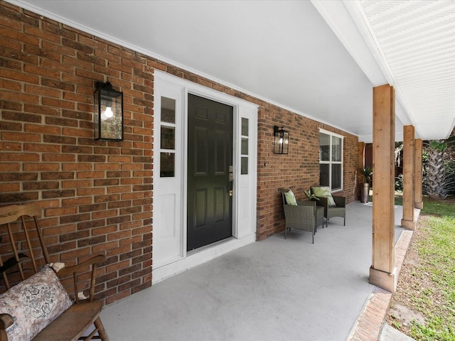 506 Dorset Cir S, Daytona, FL 32119 - view of exterior entry featuring brick siding and a porch