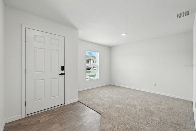 17 Roxbury Ln, Palm Coast, FL 32164 - carpeted foyer entrance with baseboards and wood finished floors