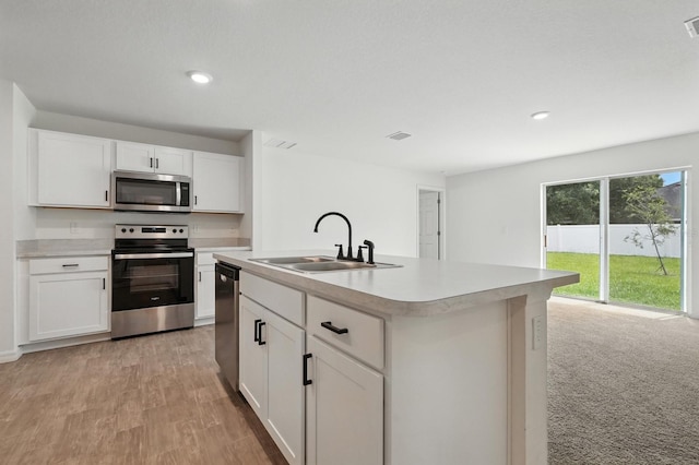 17 Roxbury Ln, Palm Coast, FL 32164 - kitchen featuring stainless steel appliances, light countertops, white cabinetry, a center island with sink, and recessed lighting