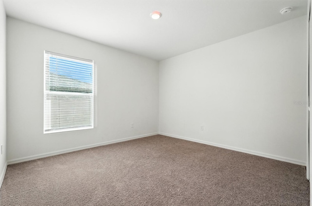 17 Roxbury Ln, Palm Coast, FL 32164 - spare room featuring carpet floors and a smoke detector