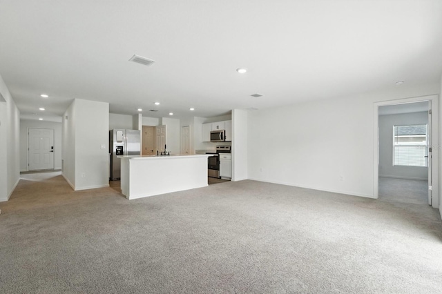 17 Roxbury Ln, Palm Coast, FL 32164 - unfurnished living room with light carpet and recessed lighting
