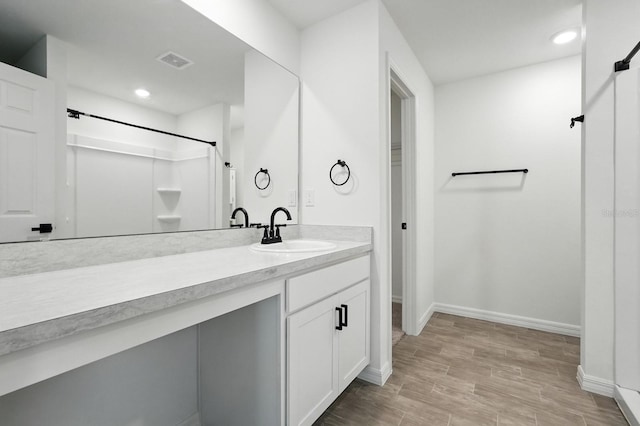 17 Roxbury Ln, Palm Coast, FL 32164 - full bath featuring vanity, a shower, wood finished floors, and recessed lighting