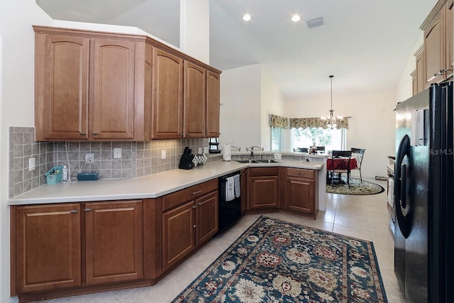 43 White Dove Ln, Palm Coast, FL 32164 - kitchen with black appliances, a peninsula, lofted ceiling, backsplash, and a chandelier