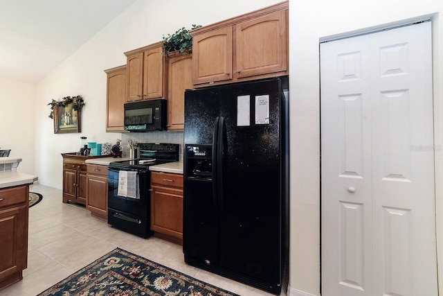 43 White Dove Ln, Palm Coast, FL 32164 - kitchen with black appliances, lofted ceiling, decorative backsplash, light countertops, and light tile patterned floors