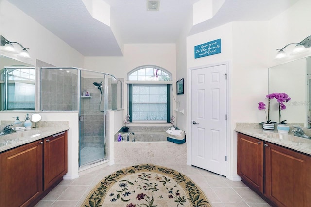 43 White Dove Ln, Palm Coast, FL 32164 - bathroom with tile patterned floors, a stall shower, a garden tub, and two vanities