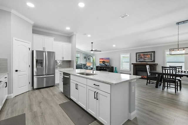 47 Lumberjack Trl, Palm Coast, FL 32137 - kitchen featuring stainless steel appliances, crown molding, tasteful backsplash, an island with sink, and recessed lighting