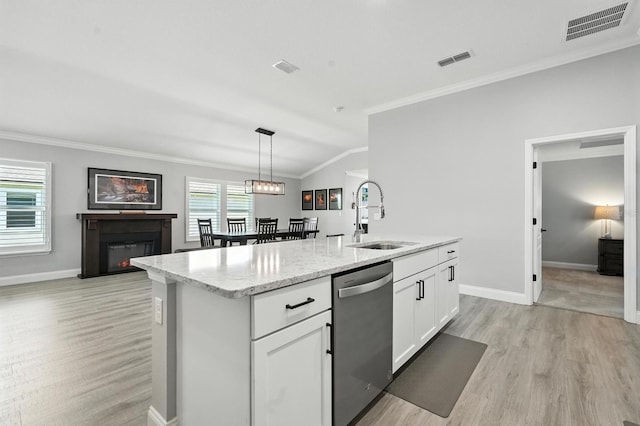 47 Lumberjack Trl, Palm Coast, FL 32137 - kitchen featuring stainless steel dishwasher, light wood-style floors, crown molding, light stone countertops, and a kitchen island with sink