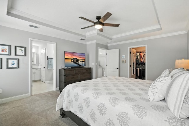 47 Lumberjack Trl, Palm Coast, FL 32137 - bedroom with a tray ceiling, a walk in closet, ornamental molding, light carpet, and a closet