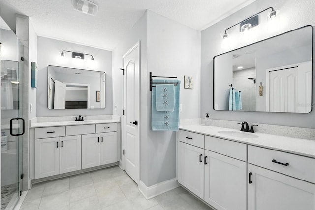 47 Lumberjack Trl, Palm Coast, FL 32137 - bathroom with a stall shower, two vanities, a textured ceiling, and tile patterned floors