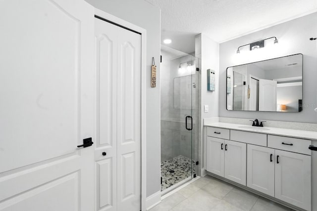 47 Lumberjack Trl, Palm Coast, FL 32137 - bathroom with tile patterned floors, a shower stall, vanity, a textured ceiling, and recessed lighting