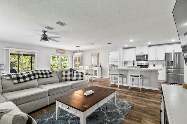 7 Grand Par Ct, Bunnell, FL 32110 - living room featuring a ceiling fan, dark wood-style floors, a textured ceiling, and recessed lighting