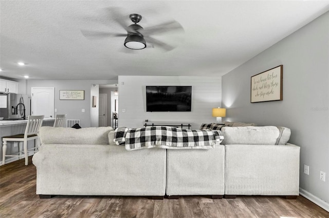 7 Grand Par Ct, Bunnell, FL 32110 - living area featuring a ceiling fan and dark wood-style floors