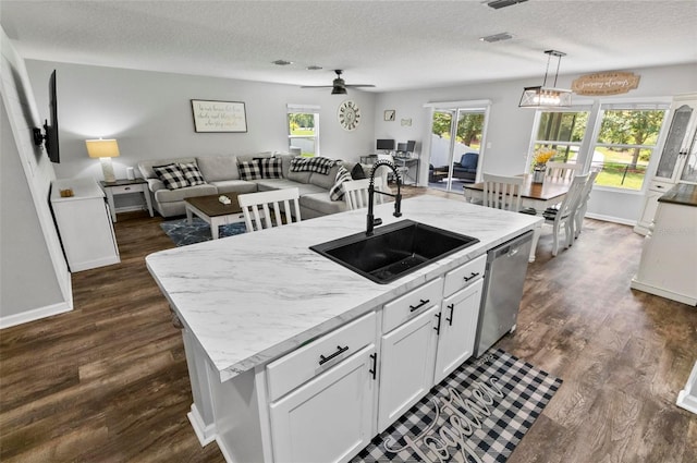 7 Grand Par Ct, Bunnell, FL 32110 - kitchen with stainless steel dishwasher, open floor plan, a ceiling fan, a textured ceiling, and dark wood-style flooring