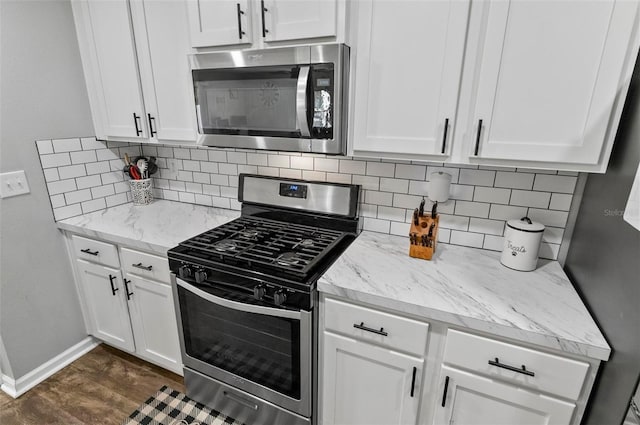 7 Grand Par Ct, Bunnell, FL 32110 - kitchen featuring stainless steel appliances, decorative backsplash, and white cabinets