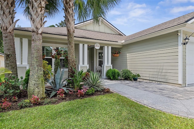 166 Midway Park Dr, Saint Augustine, FL 32084 - view of front of property featuring a porch, an attached garage, a front yard, and board and batten siding