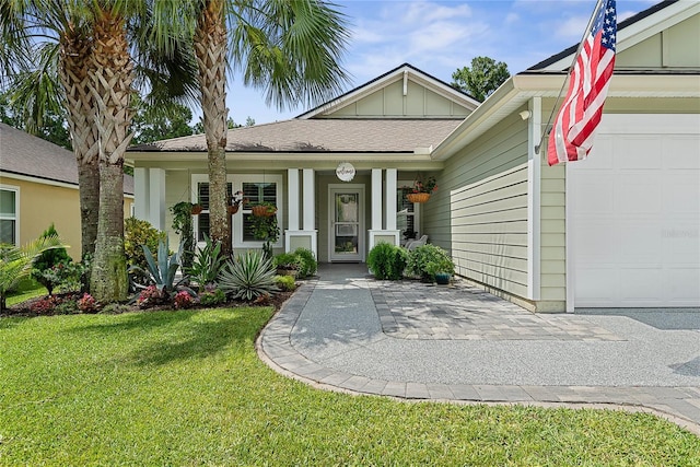 166 Midway Park Dr, Saint Augustine, FL 32084 - view of front of house with a garage, board and batten siding, a front lawn, and a porch