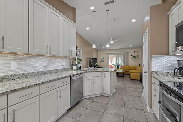166 Midway Park Dr, Saint Augustine, FL 32084 - kitchen featuring appliances with stainless steel finishes, ceiling fan, open floor plan, white cabinets, and lofted ceiling