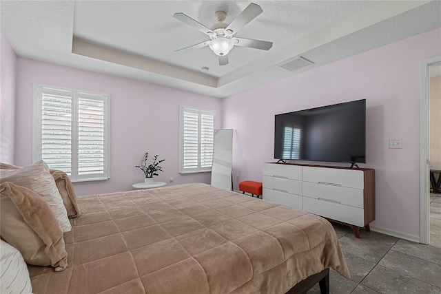 166 Midway Park Dr, Saint Augustine, FL 32084 - bedroom featuring a raised ceiling, ceiling fan, and a textured ceiling