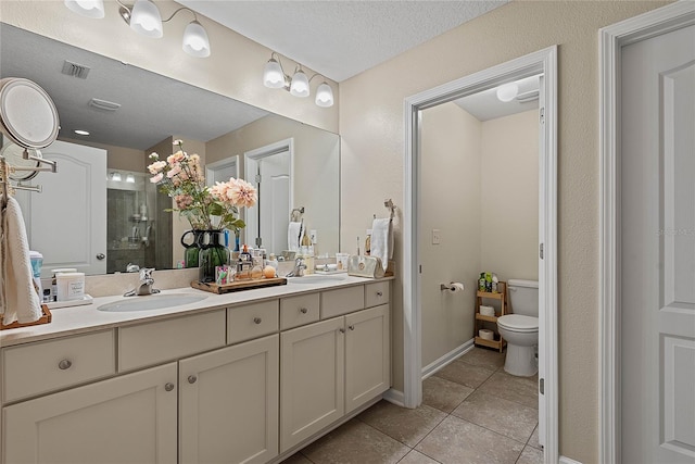 166 Midway Park Dr, Saint Augustine, FL 32084 - full bathroom with double vanity, a tile shower, tile patterned flooring, and a textured ceiling