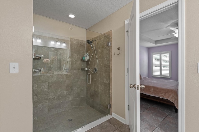 166 Midway Park Dr, Saint Augustine, FL 32084 - ensuite bathroom featuring a shower stall, tile patterned flooring, a textured ceiling, and ceiling fan