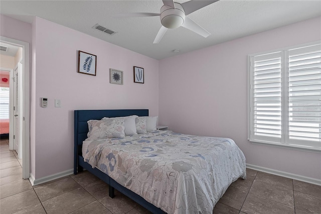 166 Midway Park Dr, Saint Augustine, FL 32084 - tiled bedroom with baseboards and a ceiling fan