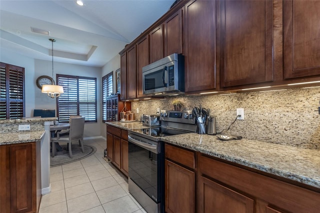 25 Raintree Cir, Palm Coast, FL 32164 - kitchen with stainless steel appliances, tasteful backsplash, light stone countertops, pendant lighting, and light tile patterned floors