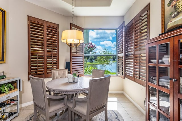 25 Raintree Cir, Palm Coast, FL 32164 - tiled dining area featuring a water view and baseboards
