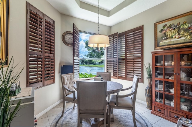25 Raintree Cir, Palm Coast, FL 32164 - dining room with light tile patterned flooring, a tray ceiling, and a chandelier