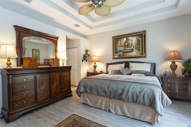 25 Raintree Cir, Palm Coast, FL 32164 - bedroom featuring a tray ceiling, light wood-style floors, and ceiling fan
