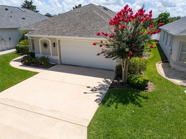 25 Raintree Cir, Palm Coast, FL 32164 - view of front of property featuring a garage, a shingled roof, concrete driveway, and a front lawn