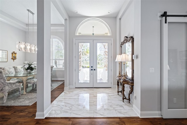 4 Old Oak Dr N, Palm Coast, FL 32137 - entryway featuring french doors, a chandelier, and a barn door
