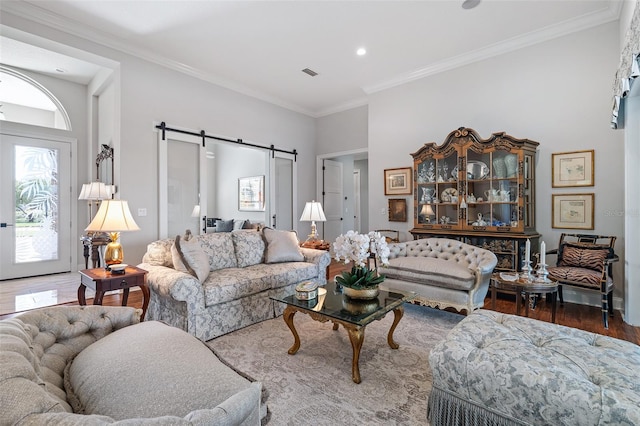 4 Old Oak Dr N, Palm Coast, FL 32137 - living room featuring a barn door, wood finished floors, recessed lighting, and ornamental molding