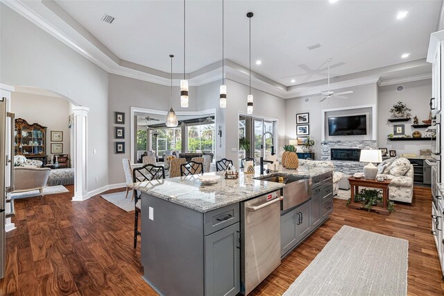 4 Old Oak Dr N, Palm Coast, FL 32137 - kitchen with stainless steel dishwasher, gray cabinets, ceiling fan, ornate columns, and a high ceiling