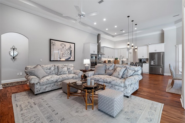 4 Old Oak Dr N, Palm Coast, FL 32137 - living room featuring a high ceiling, arched walkways, ceiling fan, dark wood-style floors, and recessed lighting