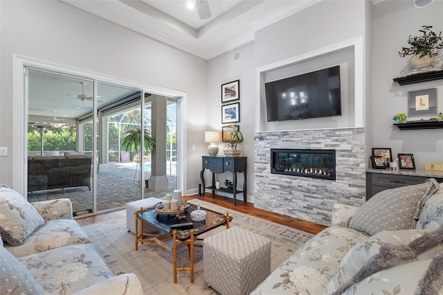 4 Old Oak Dr N, Palm Coast, FL 32137 - living area featuring a ceiling fan, wood finished floors, a stone fireplace, and ornamental molding