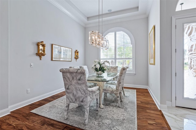 4 Old Oak Dr N, Palm Coast, FL 32137 - dining room with a chandelier, a raised ceiling, wood finished floors, and crown molding